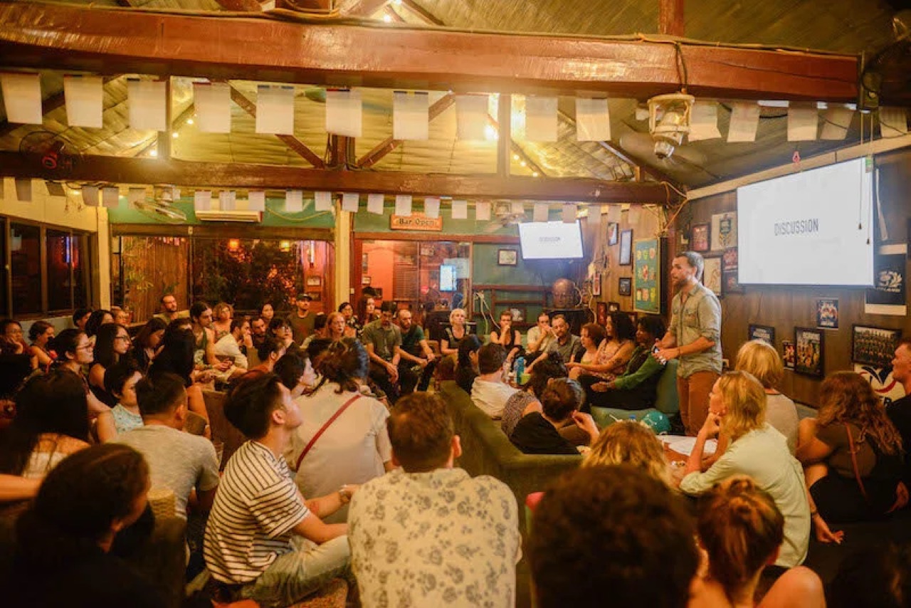 Jon hosting a Real Talk Philosophy event — packed crowd in discussion